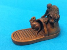 Netsuke; terrier chasing a rat on a slipper