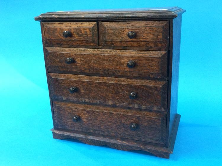 A miniature oak chest of drawers, 17cm wide