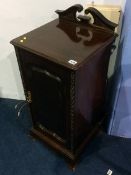 A mahogany bedside cabinet