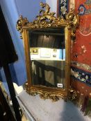 An ornate gilt mirror