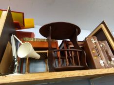 A shelf containing tables, lamp, suitcases etc.