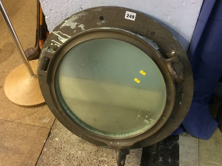 A heavy brass circular porthole, 55cm diameter