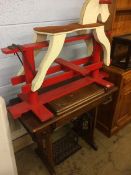 A child's red and white rocking horse and Singer treddle sewing machine