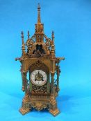 A 19th century gilt metal bracket clock of Gothic form, with eight day movement, enamelled dial,