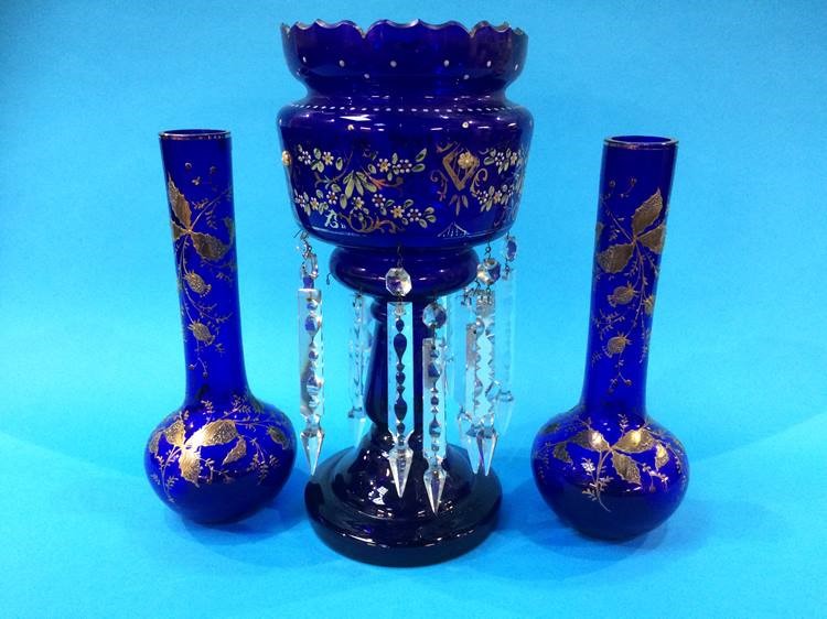 A blue glass lustre and a pair of blue and gilt vases