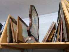 A shelf of pictures and a fire screen