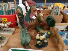 Four cockerel figures