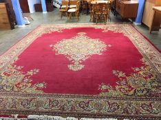 A Belgian Louis de Pootere woollen rug of Persian design, the red ground with central floral
