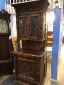 A heavily carved oak cabinet with leaded glass doors, 94 x 54 x 232cm