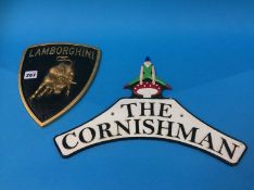 A 'Lamborghini' sign and 'The Cornishman' sign