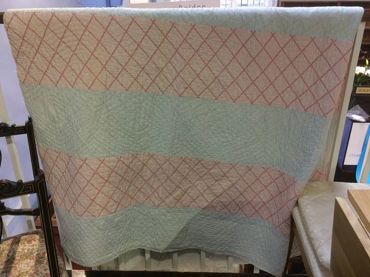 A pale blue and pink striped Durham quilt