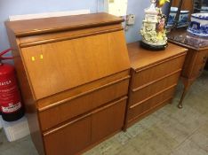 A teak bureau and chest of drawers