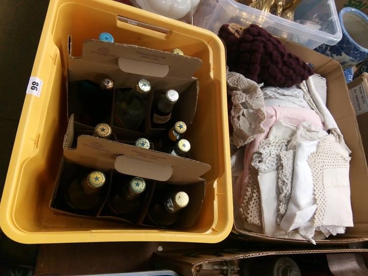 Thirteen bottles of Newcastle Brown Ale and a box of linen