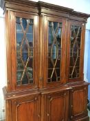 A reproduction mahogany Georgian style, break front bookcase, purchased at Barker and Stonehouse,