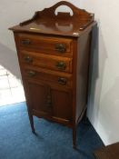 An Edwardian mahogany music cabinet