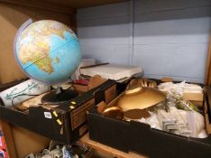 A shelf of glass frames, bread boards, globe etc.