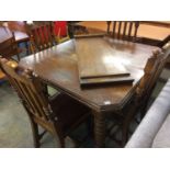 An oak extending dining table with four chairs