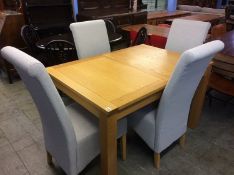 A light oak table and four chairs