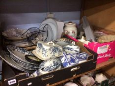 Three trays of blue and white china, pot lid etc.