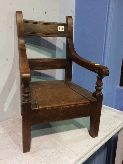 An oak child's commode chair