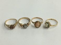 Four gold dress rings