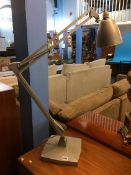 A large silver angle poise table lamp