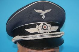 A German Luftwaffe Officer's visor cap, stamped Derkaufs Abteilung der Luftwaffe Berlin SW 68,
