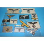 A Luftwaffe Officer's cape eagle, Army General's eagle, SS eagle emblem, a Flying Man emblem,