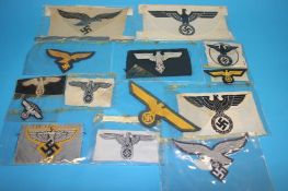 A Luftwaffe Officer's cape eagle, Army General's eagle, SS eagle emblem, a Flying Man emblem,