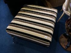 A large modern striped footstool