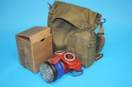 A box of World War II gas masks, various