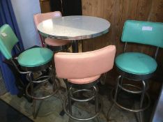 A 1950s style circular top table, with two lime green and two pink high stools