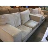 A large pair of Barker and Stonehouse type two seater settees of pale beige, with deep cushions,