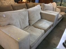 A large pair of Barker and Stonehouse type two seater settees of pale beige, with deep cushions,