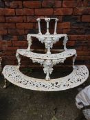 A pair of semi circular heavy cast iron plant stands, decorated with lion masks and foliage ( Please