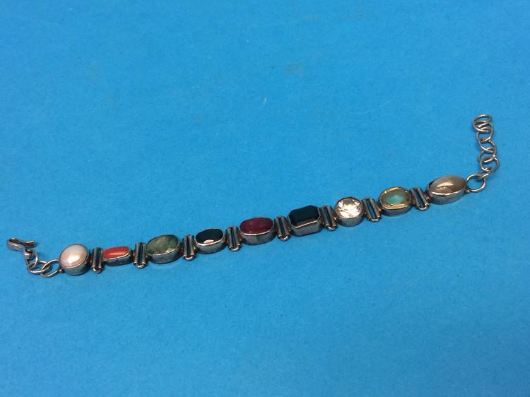 An Indian silver coloured bracelet mounted with semi precious stones