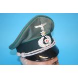 A German Gebirgstruppe (Mountain Troop) Non-Commissioned Officer's (NCO) visor cap, with metal