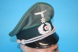 A German Gebirgstruppe (Mountain Troop) Non-Commissioned Officer's (NCO) visor cap, with metal