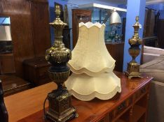 A pair of ornate metalwork decorative lamps with s