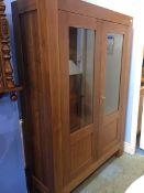 A large modern Marks and Spencer two door glazed cabinet, 131cm wide, 184cm height