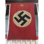 A Nazi flag, signed by the four capturing troops, 122cm x 76cm