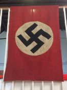 A Nazi flag, signed by the four capturing troops, 122cm x 76cm