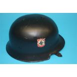 A black German World War II Police helmet, stamped Vorschrifts Massie LT Gestetz, 3.5.34