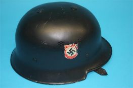 A black German World War II Police helmet, stamped Vorschrifts Massie LT Gestetz, 3.5.34
