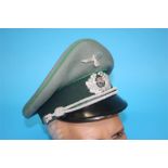 A German Jager (Light Infantry) Officer's visor cap, with green piping stamped Erel, Stirnschutz,