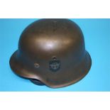 A German double decal tin helmet, stamped E.164