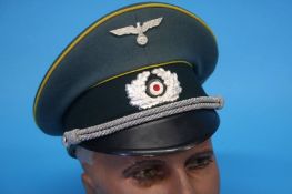 A German Signals Officer's visor cap, stamped Leonhard Paulig, Rothenburg Oder, Leparo, Fabrik