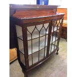 A mahogany bow front china cabinet