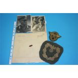 A piece of note paper stamped Adolf Hitler, a rare Diplomats sleeve eagle and a Police General's arm
