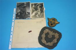 A piece of note paper stamped Adolf Hitler, a rare Diplomats sleeve eagle and a Police General's arm